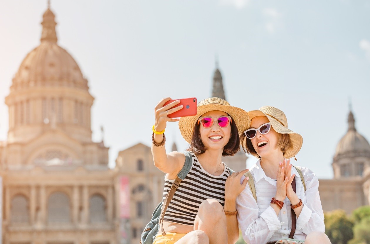 two women taking a selfie with sunhats and sunglasses on