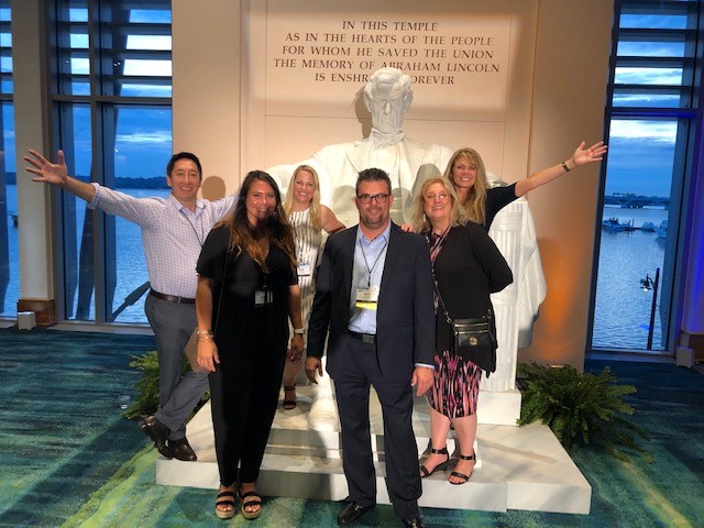 The VAX VacationAccess team and members of Universal posing together