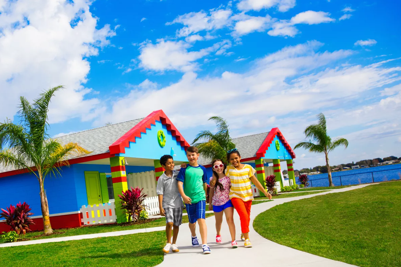 three kids walking down the sidewalk at the legoland beach retreat