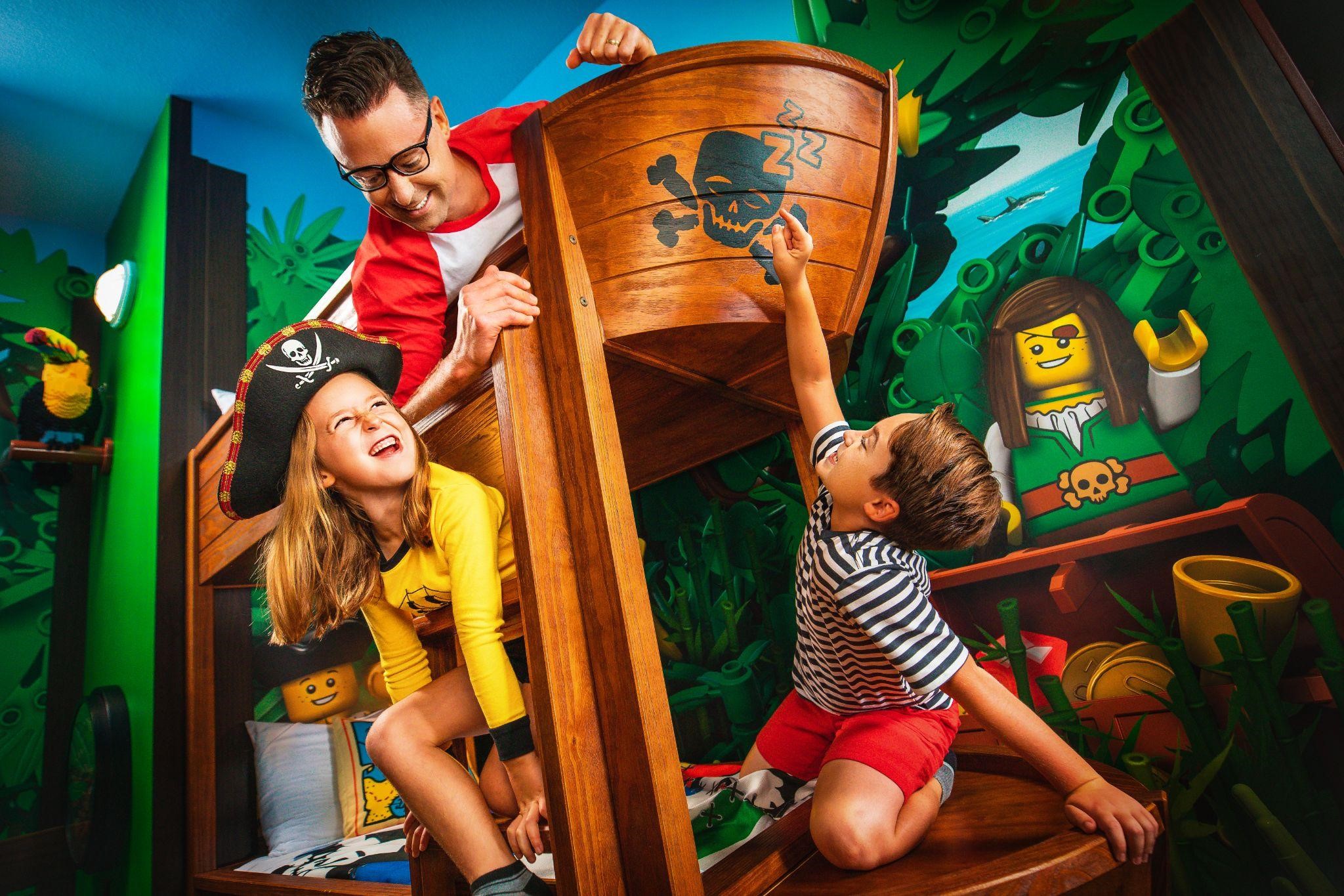 two kids and a father on a pirate ship bunk bed