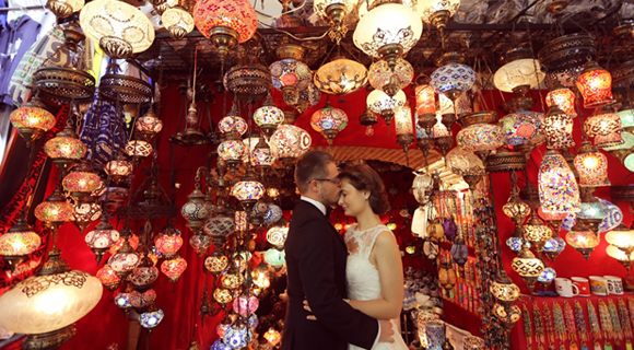 Bride and groom in a room full of Turkish lamps