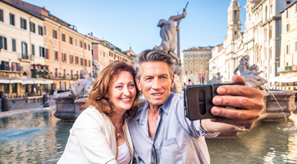 Couple taking a selfie at a fountain in Rome